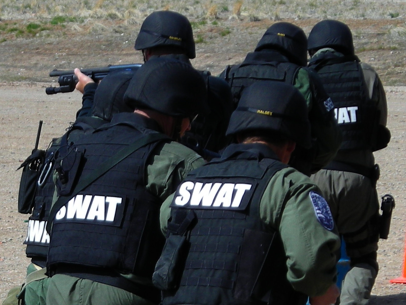 SWAT team, murder suspects in shootout; several arrested; two injured gun, ammo found