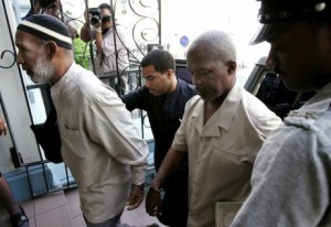 AP Photo: Kareem Ibrahim, (left), and Guyanan Abdul Kadir arrive to the Magistrate Court for an extradition hearing in Port-of-Spain, Trinidad in this 2007 photo.