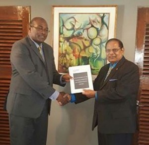 FLASH BACK: Head of the steering committee on constitutional reform, Nigel Hughes (left) delivering the report to Prime Minister Moses Nagamootoo.