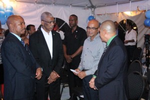 Left to right: Eureka Medical Laboratories' CEO, Andrew Boyle; President David Granger; Dr. David Singh of the Ministry of Natural Resources and Minister of Public Health, Dr. George Norton chatting after the formal commissioning of the lab's fully-solar powered building.