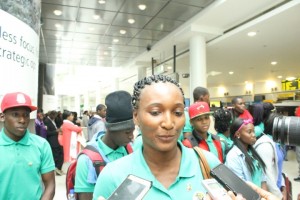 Team Manager Keisa Burnette speaking with reporters at New York's JFK Airport.