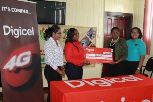 Digicel's Communications Manager, Vidya Bijlall-Sanichara and Digicel's Sponsorship Executive, Luanna Abrams  present the symbolic GYD$2 million cheque to GuyExpo's Chairperson, Dawn Holder-Alert and GuyExpo's Coordinator, Tameca Sukhdeo-Singh.