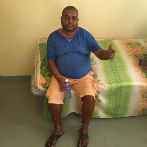 SHACKLED: Barry Dataram in custody following his arrest in a house at Latour, southern Paramaribo.