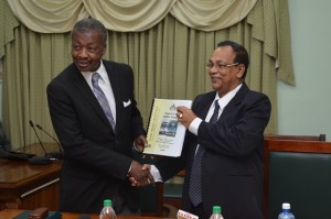 Dr. Barton Scotland, C.C.H, MP receiving the Auditor General Report from Deodat Sharma, Auditor General of Guyana. (GINA photo)