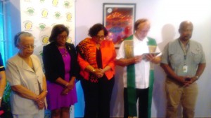 CEO Roxanne Reece (center) flanked by Minister of Public Telecommunications and Tourism Cathy Hughes; Anglican Priest, Canon Thurston Riehl and Fly Jamaica’s Chairman, Ronald Reece as the priest prays just before the cutting of the ribbon to open the airline’s Georgetown office.