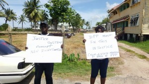 Courtney Crum-Ewing's parents, Eustace and Donna Harcourt protesting outside the Chambers of the Director of Public Prosecutions.