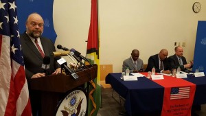 US Ambassador, Perry Holloway at the lectern. Seated are (left to right) Guyana's  Foreign Minister, Carl Greenidge; Natural Resources Minister, Raphael Trotman and Carter Centre's Country Representative, Jason Calder.