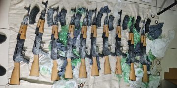 Ten AK-47 assault rifles found on Corentyne public road, one arrested, two vehicles held